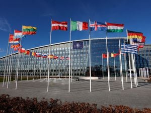 Flags flutter in the wind outside Nato headquarters in Brussels