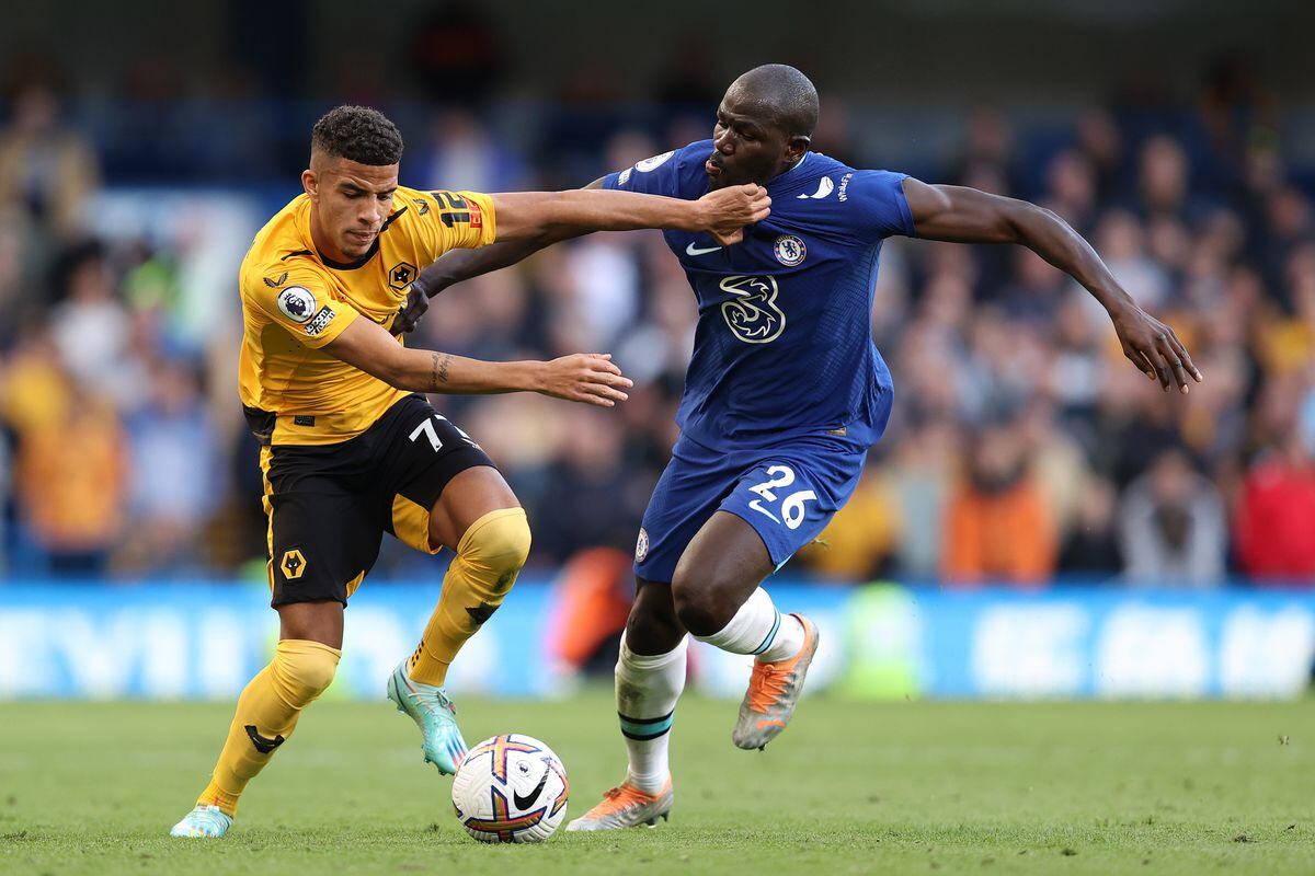 Chem Campbell of Wolverhampton Wanderers is challenged by Kalidou Koulibaly of Chelsea during the Premier League match between Chelsea FC and Wolverhampton Wanderers at Stamford Bridge on October 08, 2022 in London, England. (Photo by Jack Thomas - WWFC/Wolverhampton Wanderers FC via Getty Images).