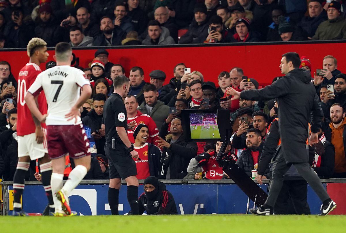 Referee Michael Oliver consults VAR to decide on Aston Villa's Danny Ings' goal during the Emirates FA Cup third round match at Old Trafford