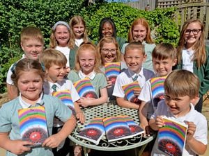 Ella Fletcher pictured with the children who contributed to the book, from Pool Hayes, Bentley West and Westfield primary schools