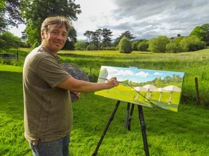 Artist David Johnson paints the site as the discussions about its future go on