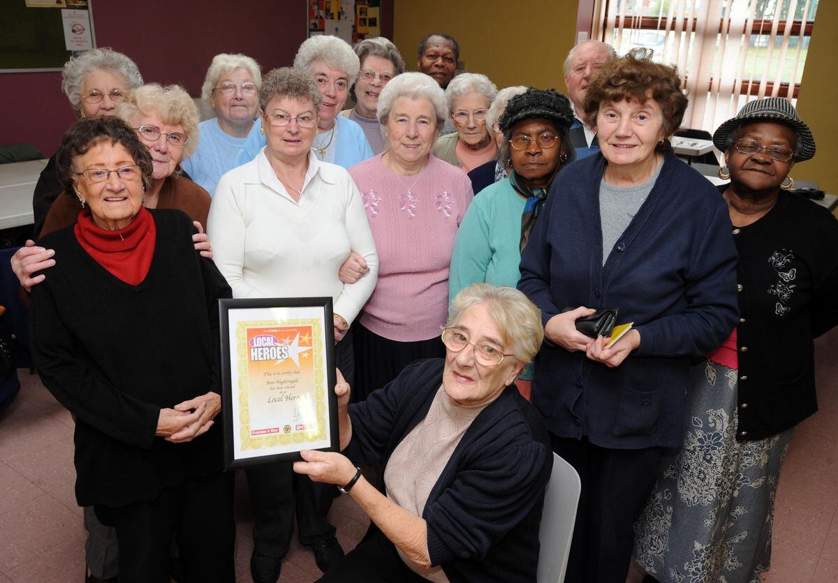 Ann Nightingale with her Express & Star Local Hero award at the Lunt Community in Bilston with members of the bingo club.