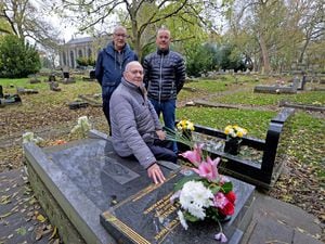 Bill Jones, front, next to his wife Margaret's and son Robert's grave, with Dennis Watkins, back left and and Bill's other son, Dave