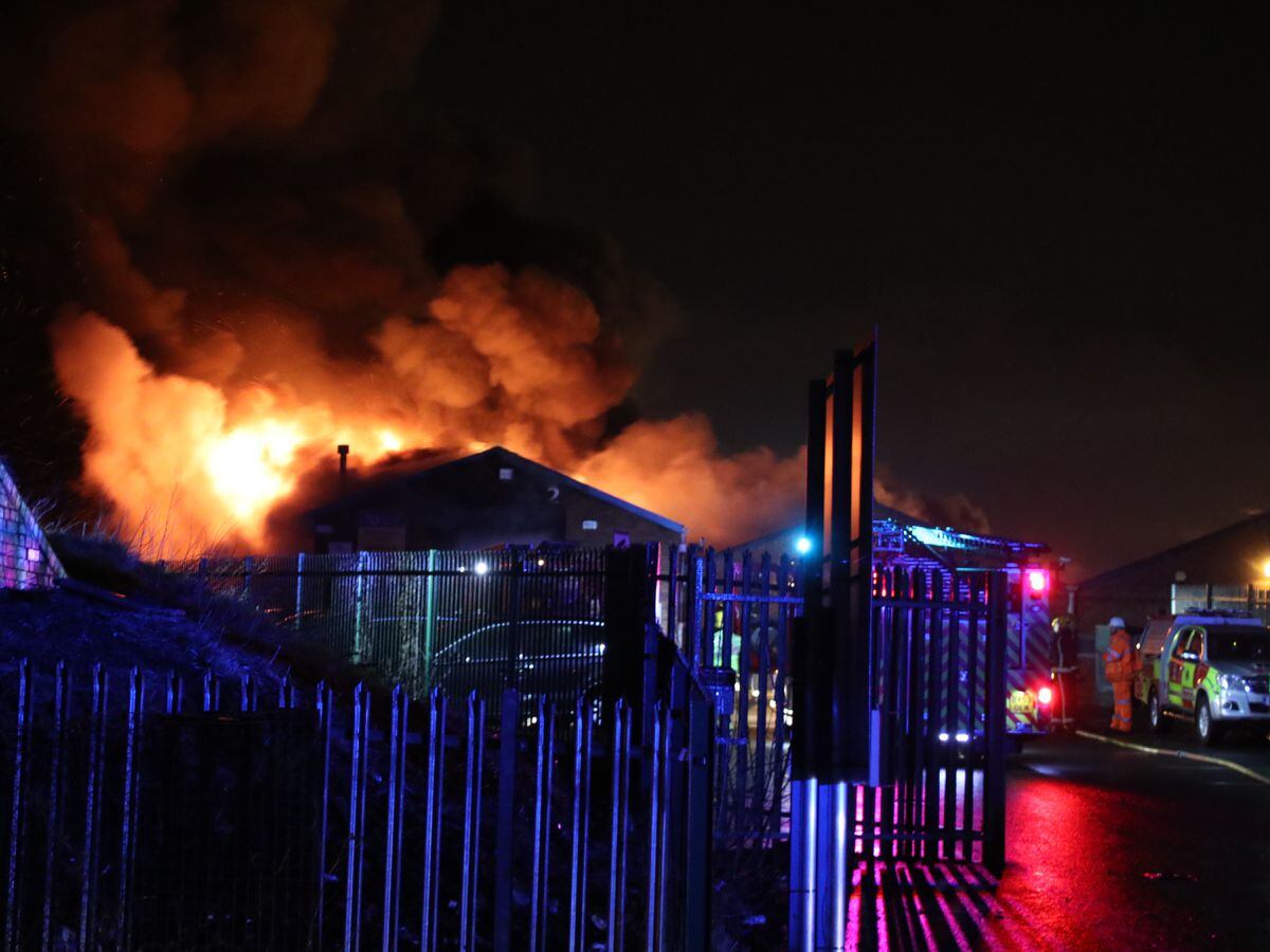Flames burst from the factory. Picture: Damien Martin
