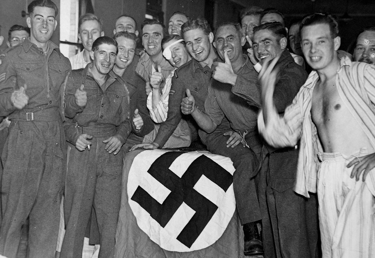 Wounded soldiers with their captured Nazi flag at Wordsley Emergency Hospital in 1943