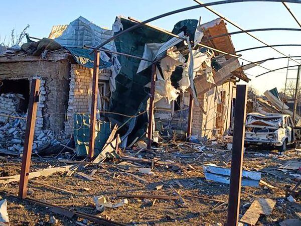 A damaged building and a car are seen after a Russian strike in the village of Novosofiivka in the Zaporizhzhia region, Ukraine, on Monday December 5 2022