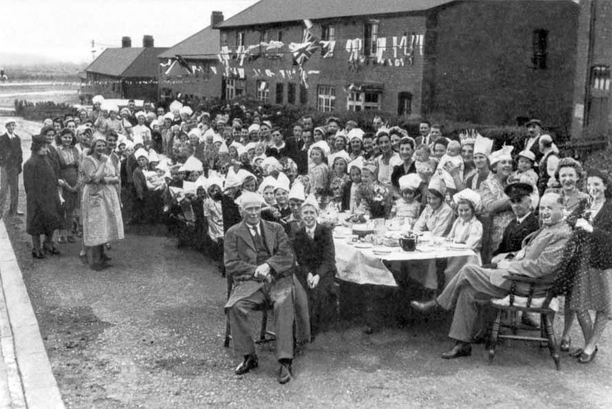 As Poultney Street residents celebrated in West Bromwich they were joined by the Mayor of West Bromwich, Councillor John J. Grant, who is seated, right. 