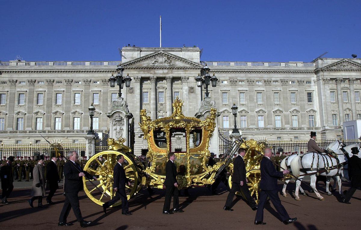 The Gold State Coach makes its way past Buckingham Palace during a rehearsal for the Queen's Golden Jubilee celebrations in 2002