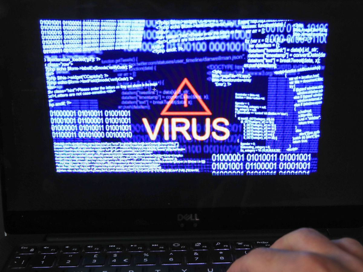 A stock image of a laptop screen showing a computer virus warning