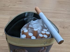 The shopkeeper was selling single cigarettes out of a tin