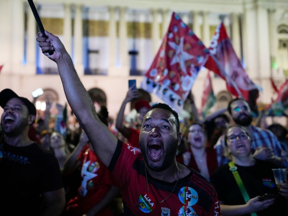 Followers of former Brazilian President Luiz Inacio Lula da Silva, who is running for president again, react to the partial results after general election polls closed in Rio de Janeiro, Brazil, Sunday, Oct. 2, 2022
