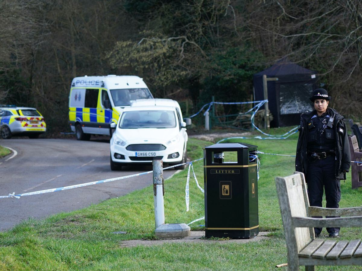 Police at the scene at Gravelly Hill in Caterham, Surrey