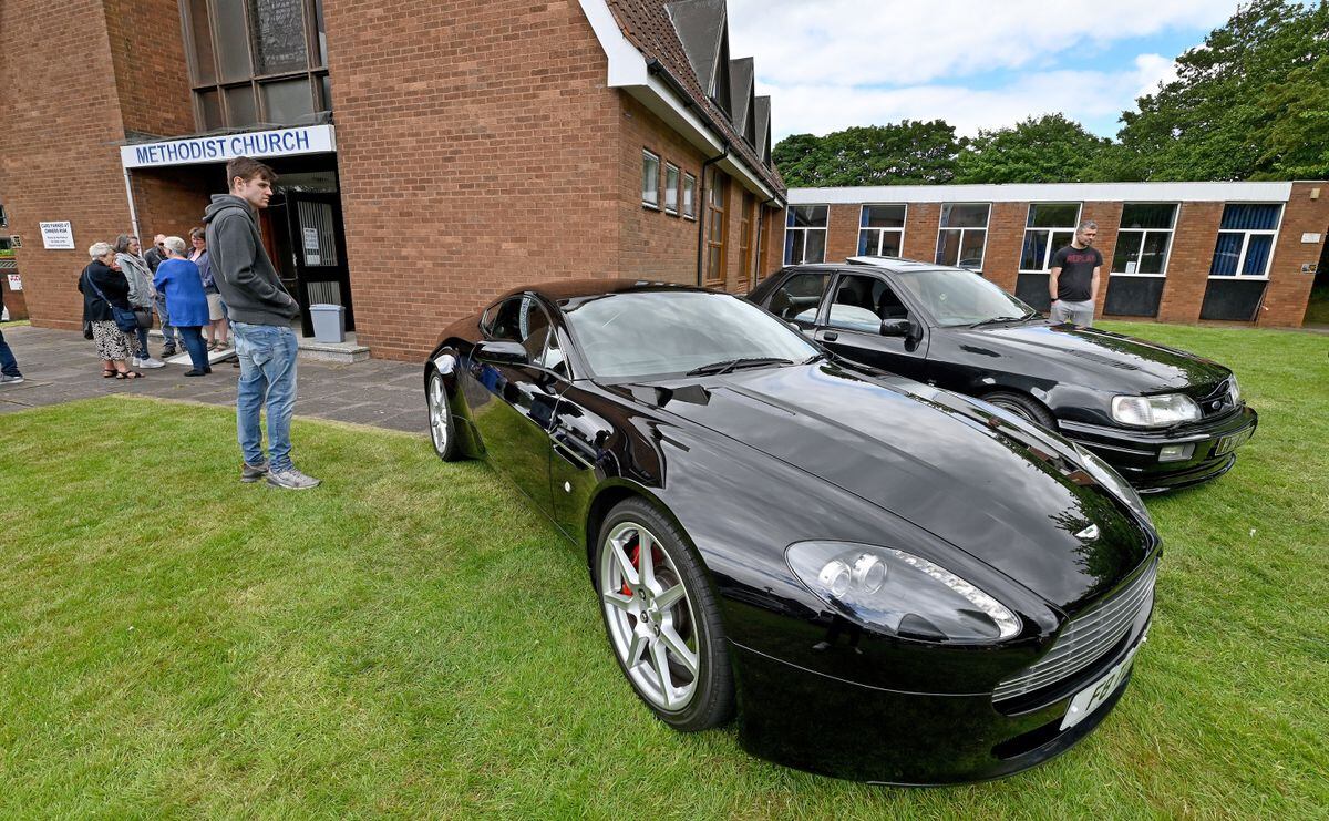 An Aston Martin Vantage takes pride of place outside