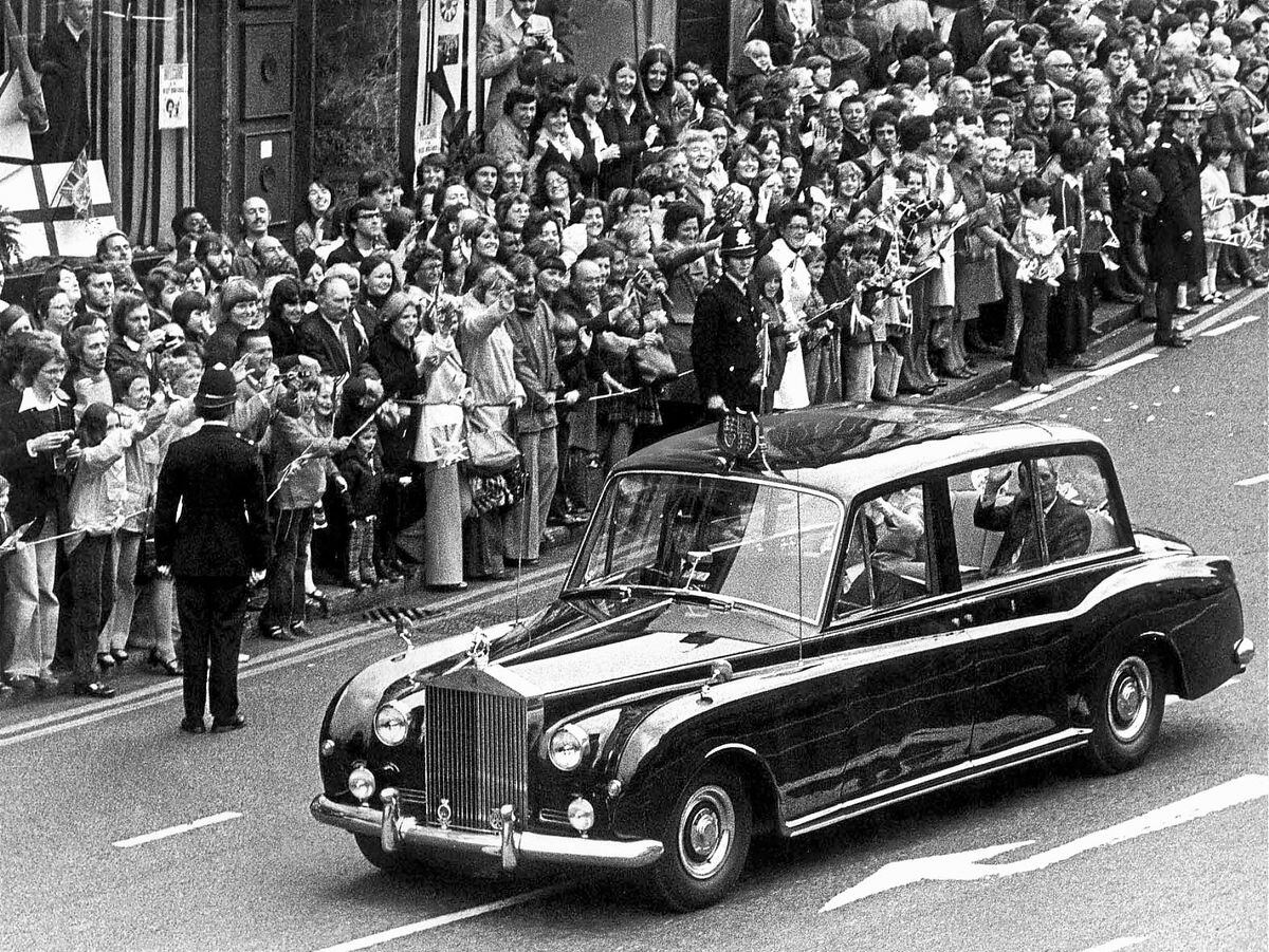 The Queen and Duke of Edinburgh's Rolls-Royce was pictured sweeping through the streets of Wolverhampton during their Silver Jubilee tour of the West Midlands in 1977. The car broke down at Walsall and mechanics Chris Tate and Fred Budd were called to repair it