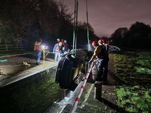 The car was craned out of the canal after dark. Photo: Lee Bates