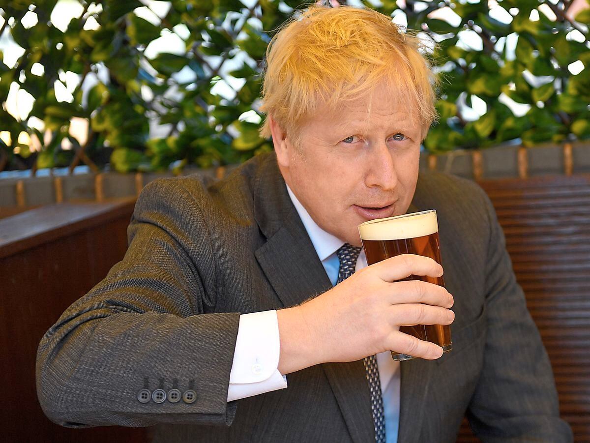 Boris Johnson enjoying a pint during a visit to The Mount Tavern in Wolverhampton in 2021