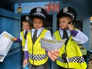 Alteja Diring, four, Miya Hira, four, and Kayde Eagleton, five, in the police station at Bushbury Lane Academy School