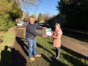 Andy Whitehouse of the Canal & River Trust presents an adoption certificate to Park Hall Junior Academy pupil Dora. PIC: Gurdip Thandi LDR