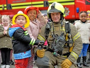 Firefighters speaking to children from Graiseley Primary School, Wolverhampton. Pictured front left: Nathan Yu Hey Tang aged four; Yvette Uduebho aged three; and firefighter Owen Hodson.