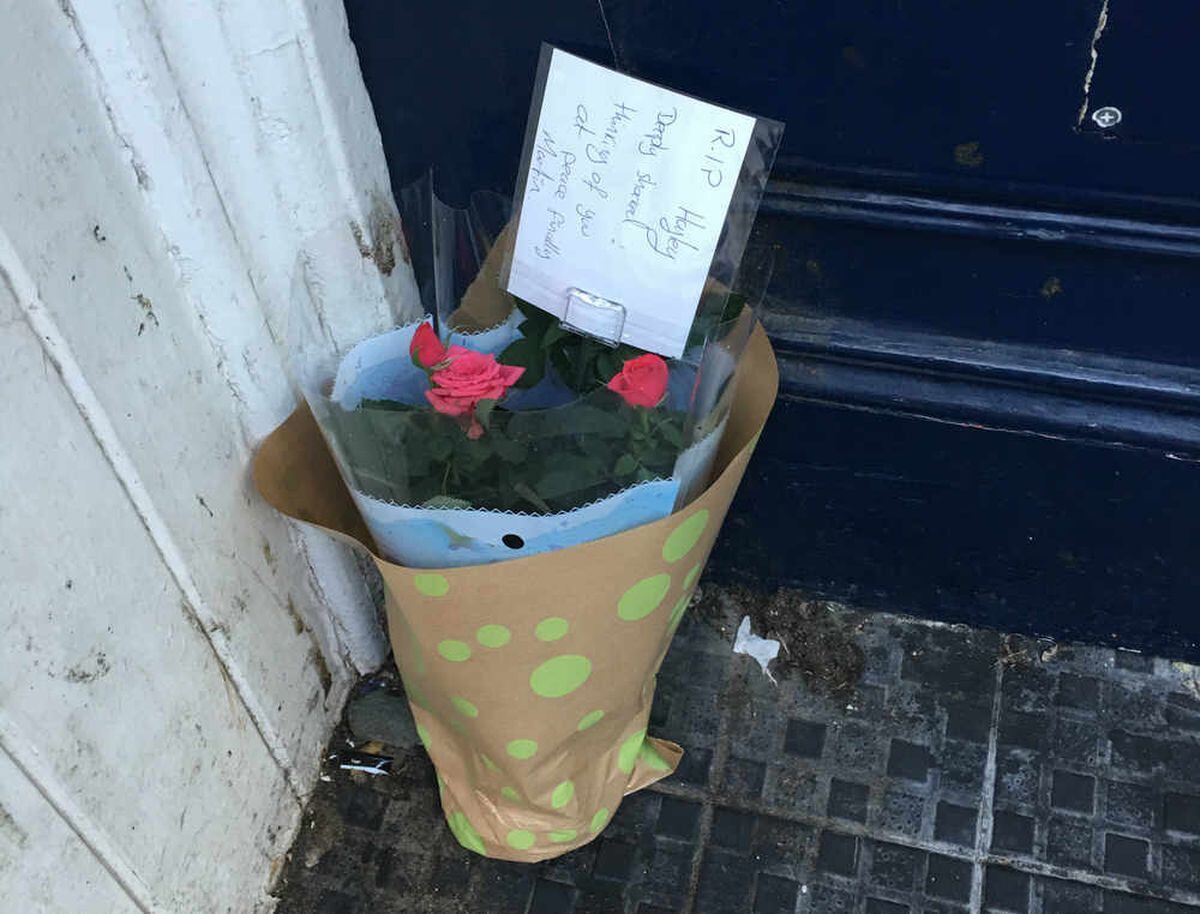 Flowers were left in the doorway of a building next to the Nando's where the body was found