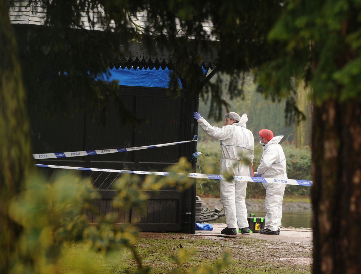 Forensic teams search around the black-coloured wooden pavilion in West Park