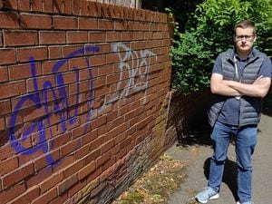 Councillor Ellis Turrell with some of the graffiti