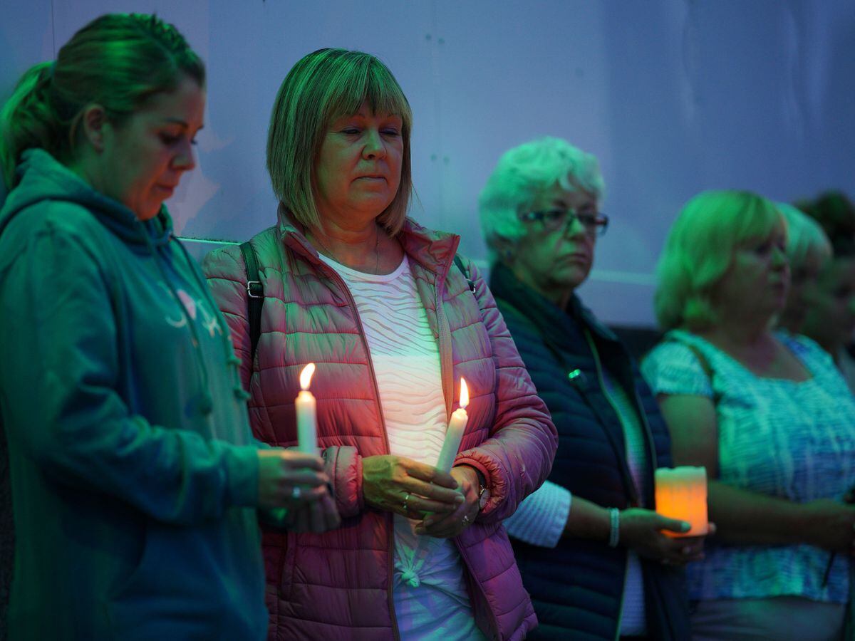 Members of the public hold candles while attending a vigil for the community in Plymouth, Devon, where five people were killed by gunman Jake Davison