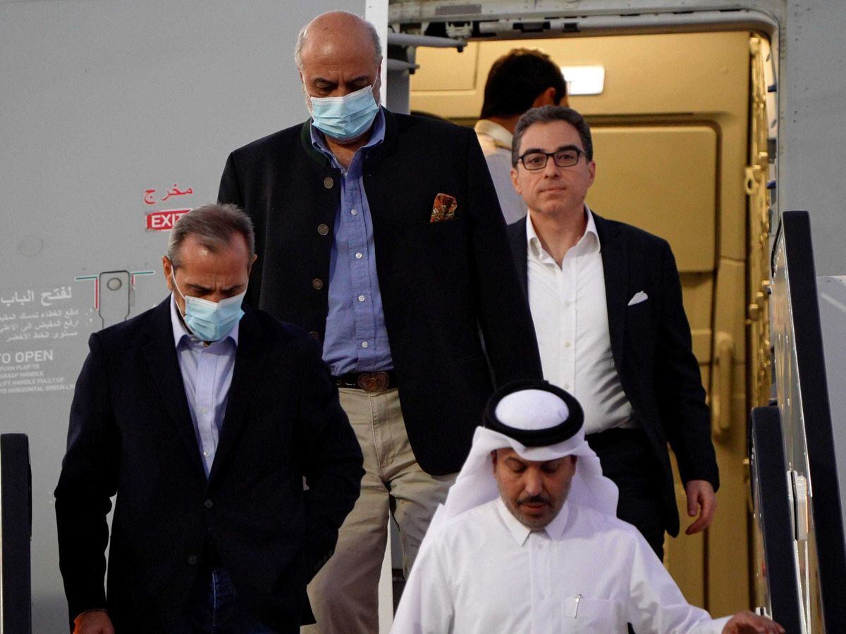 From left: Emad Sharghi, Morad Tahbaz and Siamak Namazi exit a Qatar Airways flight from Iran to Qatar