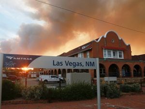 A sunset seen through a wall of wildfire smoke from the Amtrak train station in Las Vegas, New Mexico, on Saturday May 7 2022