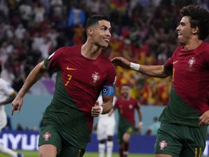 Portugal's Cristiano Ronaldo, left, celebrates with teammate Joao Felix after scoring from the penalty spot his side's opening goal against Ghana during a World Cup group H soccer match at the Stadium 974 in Doha, Qatar, Thursday, Nov. 24, 2022. (AP Photo/Manu Fernandez).