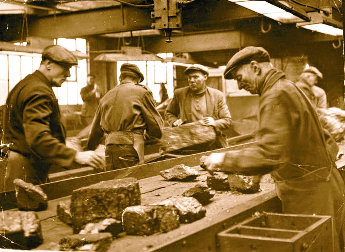This photograph, dated November 1960, shows workers sorting coal by hand at Littleton Colliery, Cannock