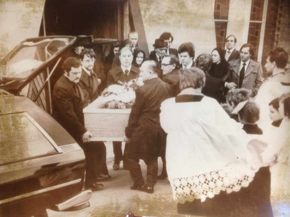 The coffin of victims the Di Marias is carried from the church.