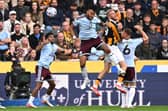 AERIAL BATTLE: Aston Villa's Tyrone Mings (centre) competes with Oli McBurnie for the ball (Image: Press Association)