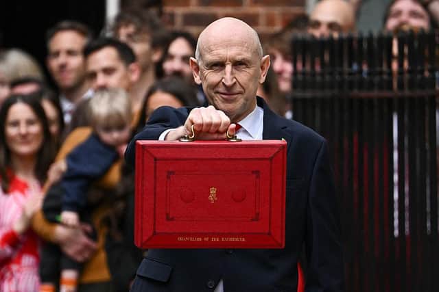 Chancellor of the Exchequer John Healey holds up the traditional red ministerial box outside No 11 Downing Street before delivering his Budget