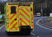 A man was rushed to hospital after being treated on the side of a road