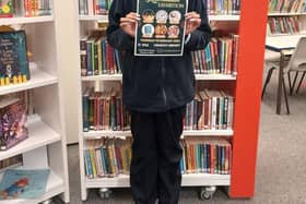 Cradley Library member of staff with the exhibition poster