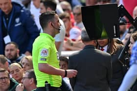 Referee Chris Kavanagh consults a pitch-side monitor (Image: Glyn KIRK / AFP)