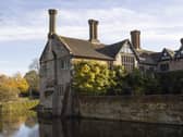View across the moat towards the Gatehouse and Entrance Range to the left, and the north side of the Courtyard at Baddesley Clinton, Warwickshire. Credit: National Trust Images/James Beck.